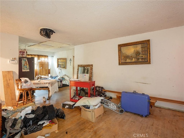 misc room with hardwood / wood-style floors and a textured ceiling