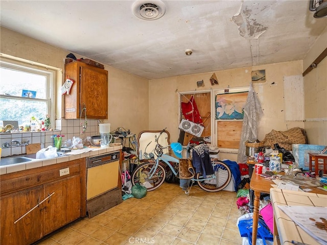 kitchen with tile countertops and decorative backsplash