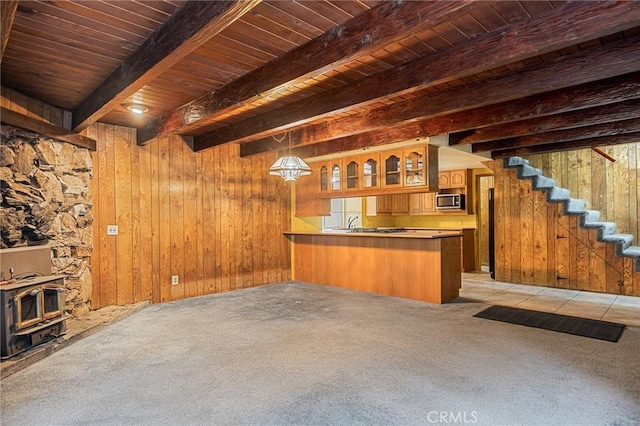 bar featuring wood walls, beamed ceiling, light colored carpet, and wooden ceiling