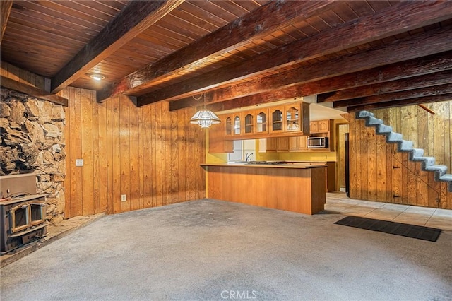 31413 Overhill Dr, Running Springs, CA 92382 - indoor wet bar featuring stainless steel microwave, light carpet, a wood stove, stairway, and a wooden ceiling with exposed beams