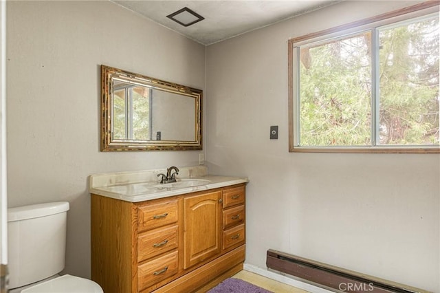 bathroom with vanity, toilet, and a wealth of natural light