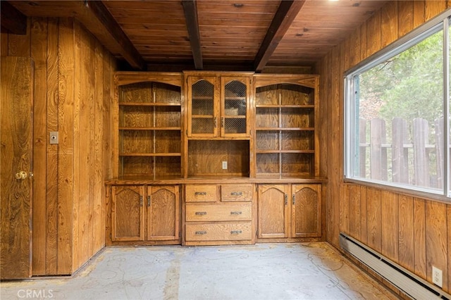 interior space featuring wood walls, wood ceiling, and a baseboard heating unit