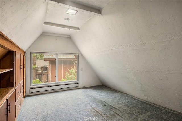 additional living space with vaulted ceiling with beams, carpet, and a baseboard heating unit