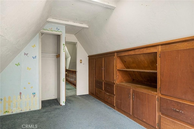 bonus room with dark carpet and lofted ceiling