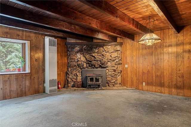 31413 Overhill Dr, Running Springs, CA 92382 - unfurnished living room with a heating unit, a wood stove, a wood ceiling with exposed beams, carpet, and wooden walls