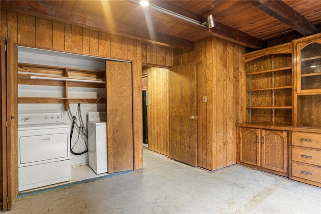 interior space with washer and dryer, beam ceiling, wooden ceiling, and wooden walls