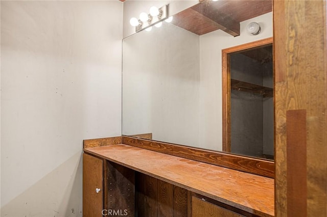 bathroom featuring vanity and beamed ceiling