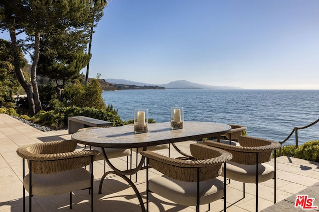 view of patio with a water and mountain view