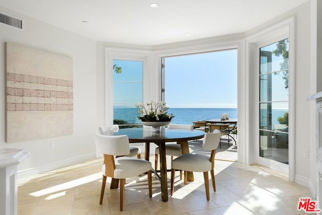 tiled dining room with a water view