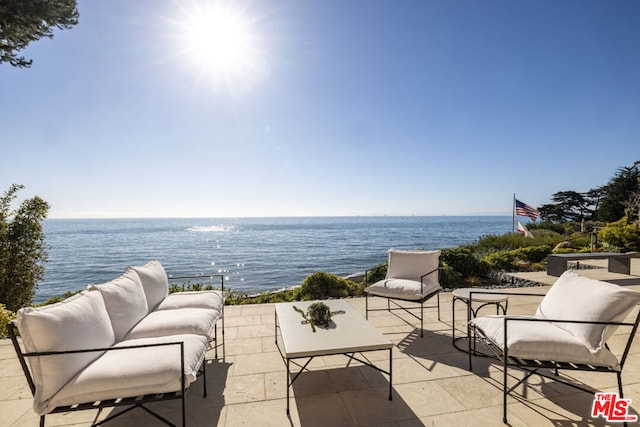 view of patio featuring outdoor lounge area and a water view