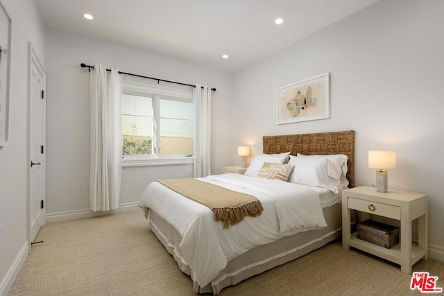 bedroom featuring light carpet