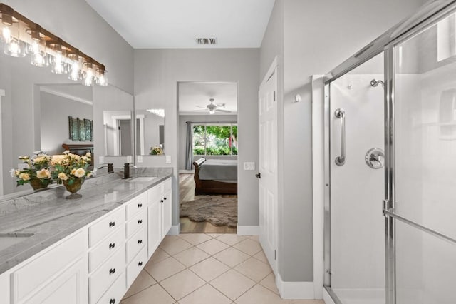 bathroom with ceiling fan, tile patterned flooring, vanity, and walk in shower