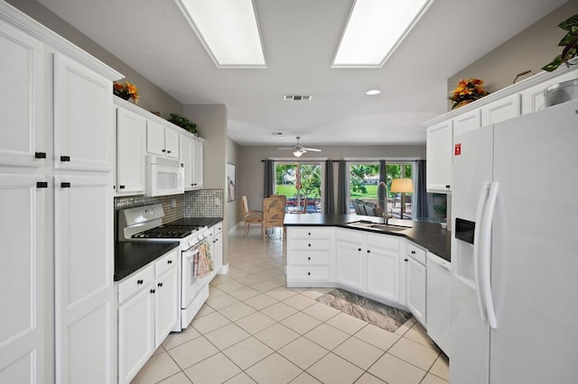 kitchen featuring white appliances, white cabinetry, ceiling fan, and sink