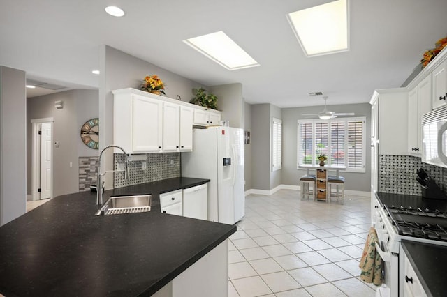 kitchen with white cabinets, white appliances, tasteful backsplash, and sink