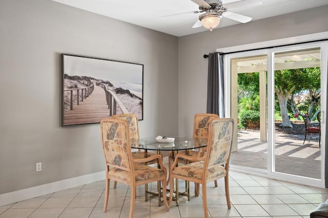 dining space with ceiling fan and light tile patterned flooring