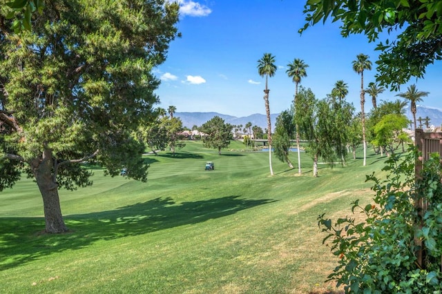 surrounding community featuring a mountain view and a yard