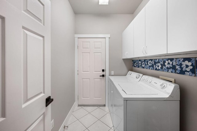 washroom with cabinets, separate washer and dryer, and light tile patterned floors