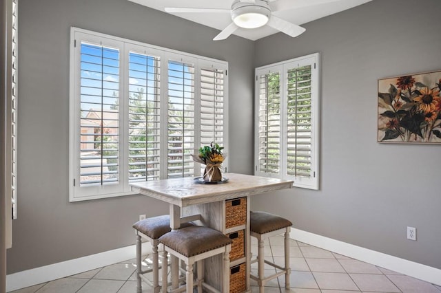 dining room with ceiling fan, a wealth of natural light, and light tile patterned flooring