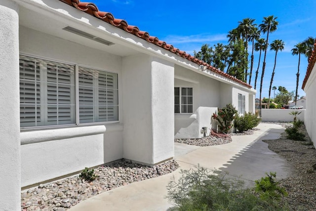 view of property exterior with a patio