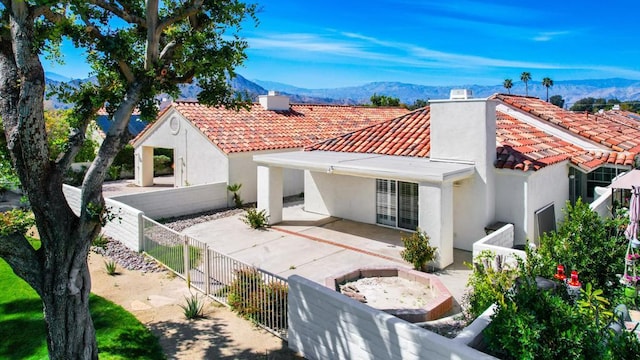 back of property featuring french doors, a patio area, and a mountain view