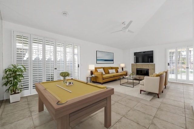 game room with ceiling fan, light tile patterned floors, a tiled fireplace, and pool table