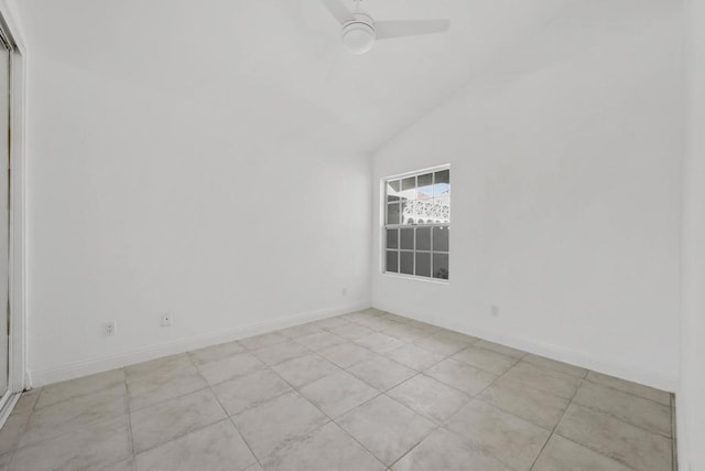 empty room featuring vaulted ceiling, ceiling fan, and light tile patterned floors