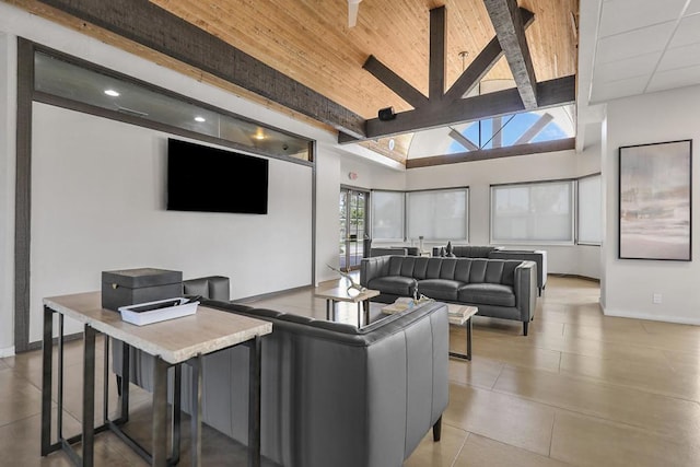 living room with beam ceiling and high vaulted ceiling