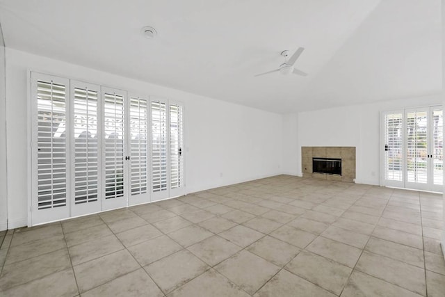 unfurnished living room with ceiling fan, light tile patterned flooring, and a fireplace