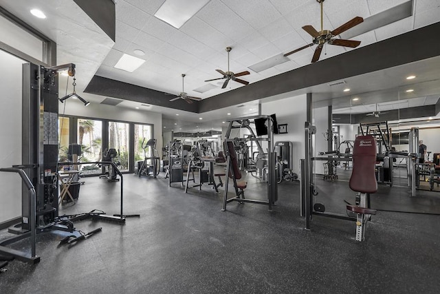 exercise room featuring a raised ceiling