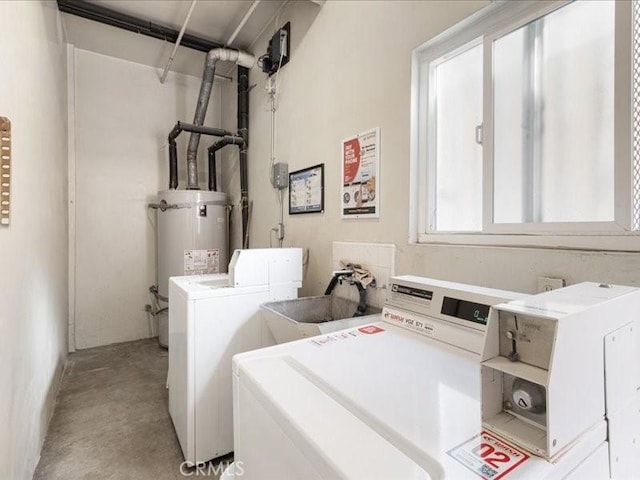 washroom with washer and clothes dryer, sink, and water heater