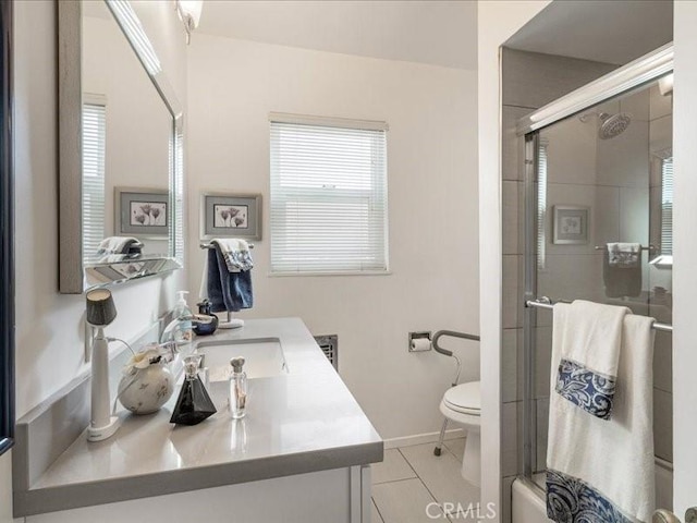 full bathroom featuring tile patterned floors, vanity, bath / shower combo with glass door, and toilet