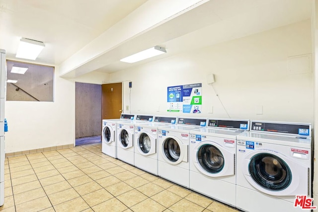 clothes washing area featuring light tile patterned floors and independent washer and dryer