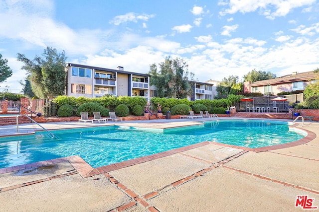 view of swimming pool with a patio