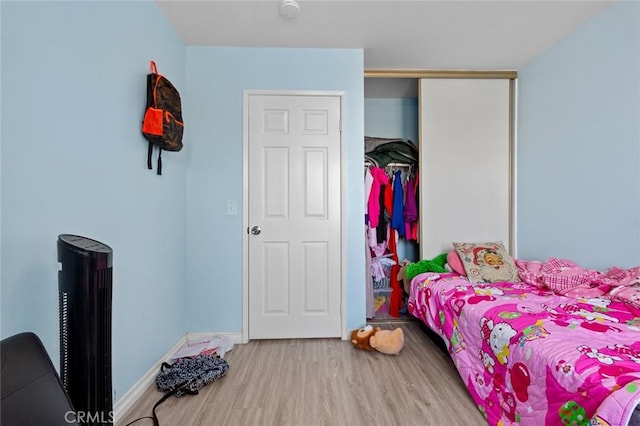 bedroom featuring hardwood / wood-style flooring and a closet