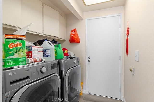 laundry area with hardwood / wood-style floors, cabinets, and independent washer and dryer