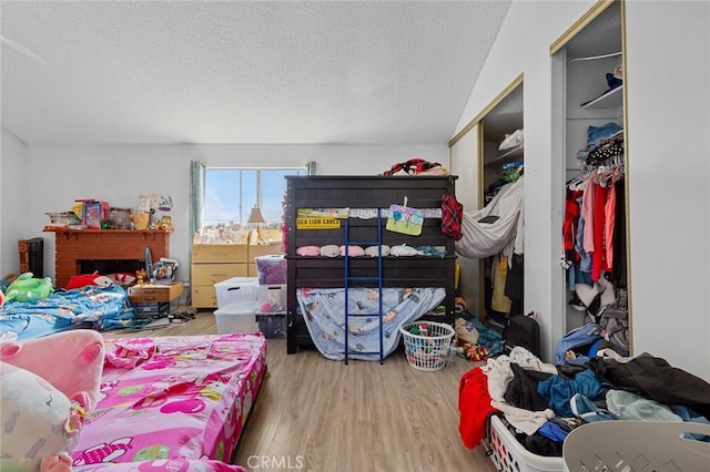 bedroom featuring a closet, a textured ceiling, and hardwood / wood-style flooring