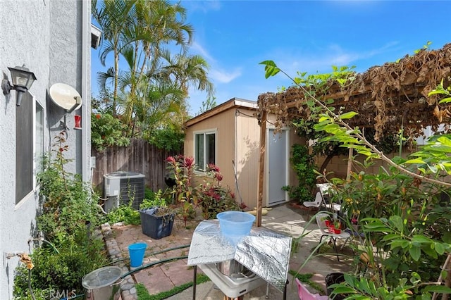 view of patio with a shed and central air condition unit