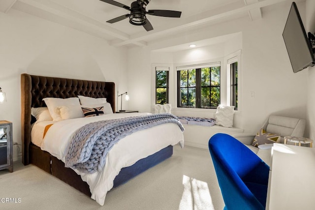 bedroom with beamed ceiling, ceiling fan, and light colored carpet