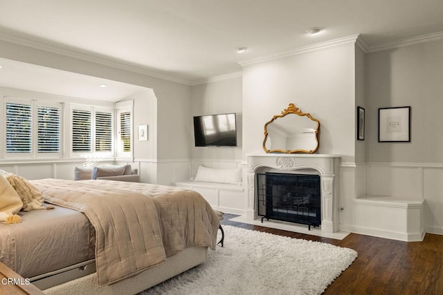 bedroom with dark hardwood / wood-style flooring and ornamental molding