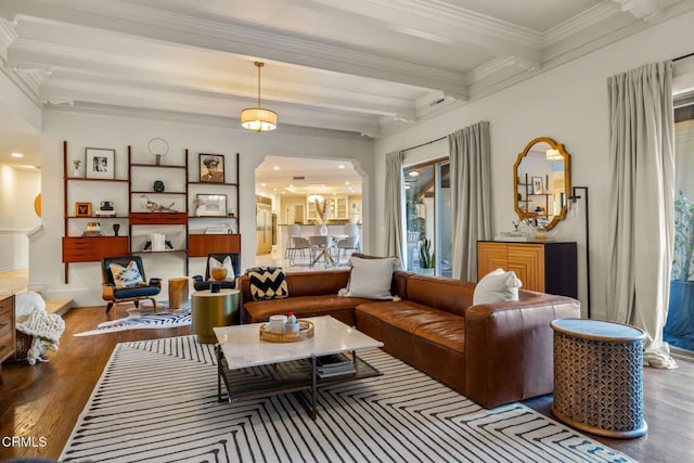 living area with beamed ceiling, hardwood / wood-style floors, and ornamental molding