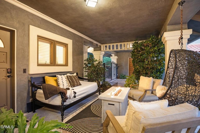 view of patio with an outdoor living space with a fire pit