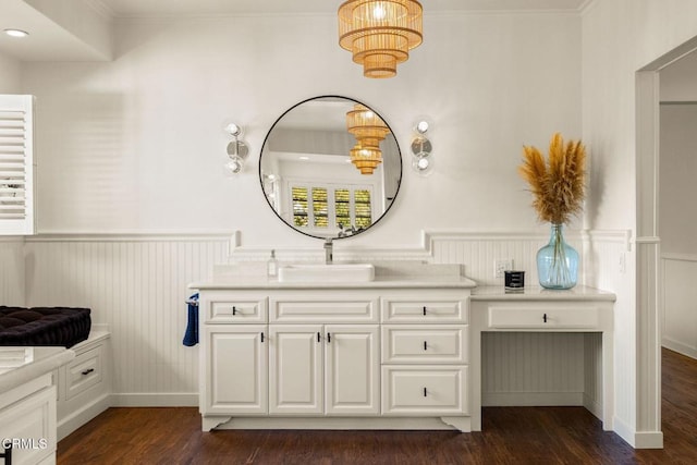 bathroom with crown molding, vanity, and hardwood / wood-style flooring