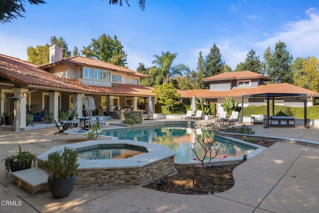 view of swimming pool with an outdoor living space, a patio area, and an in ground hot tub