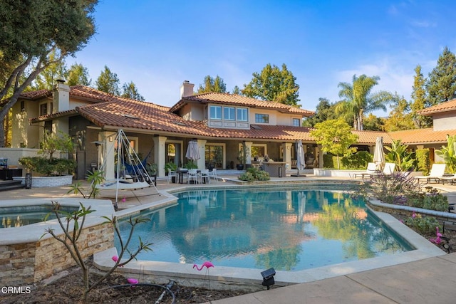 rear view of property featuring a patio