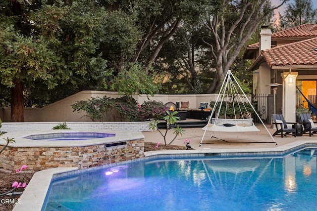 view of swimming pool featuring a patio area and an in ground hot tub