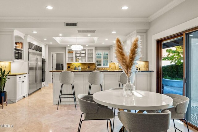 dining area featuring a tray ceiling and crown molding