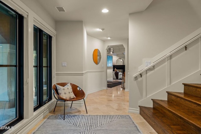 corridor featuring a healthy amount of sunlight and light tile patterned floors