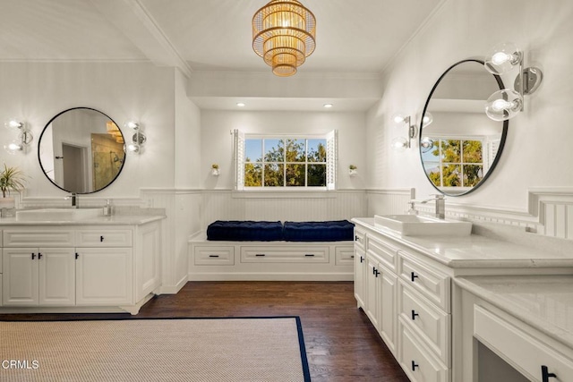 bathroom featuring vanity, hardwood / wood-style flooring, and crown molding