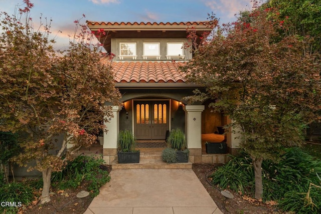 exterior entry at dusk with a porch