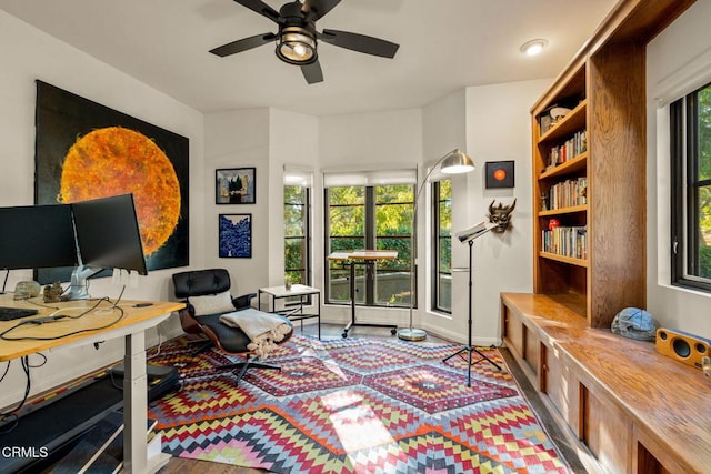 home office with hardwood / wood-style flooring, ceiling fan, and a healthy amount of sunlight